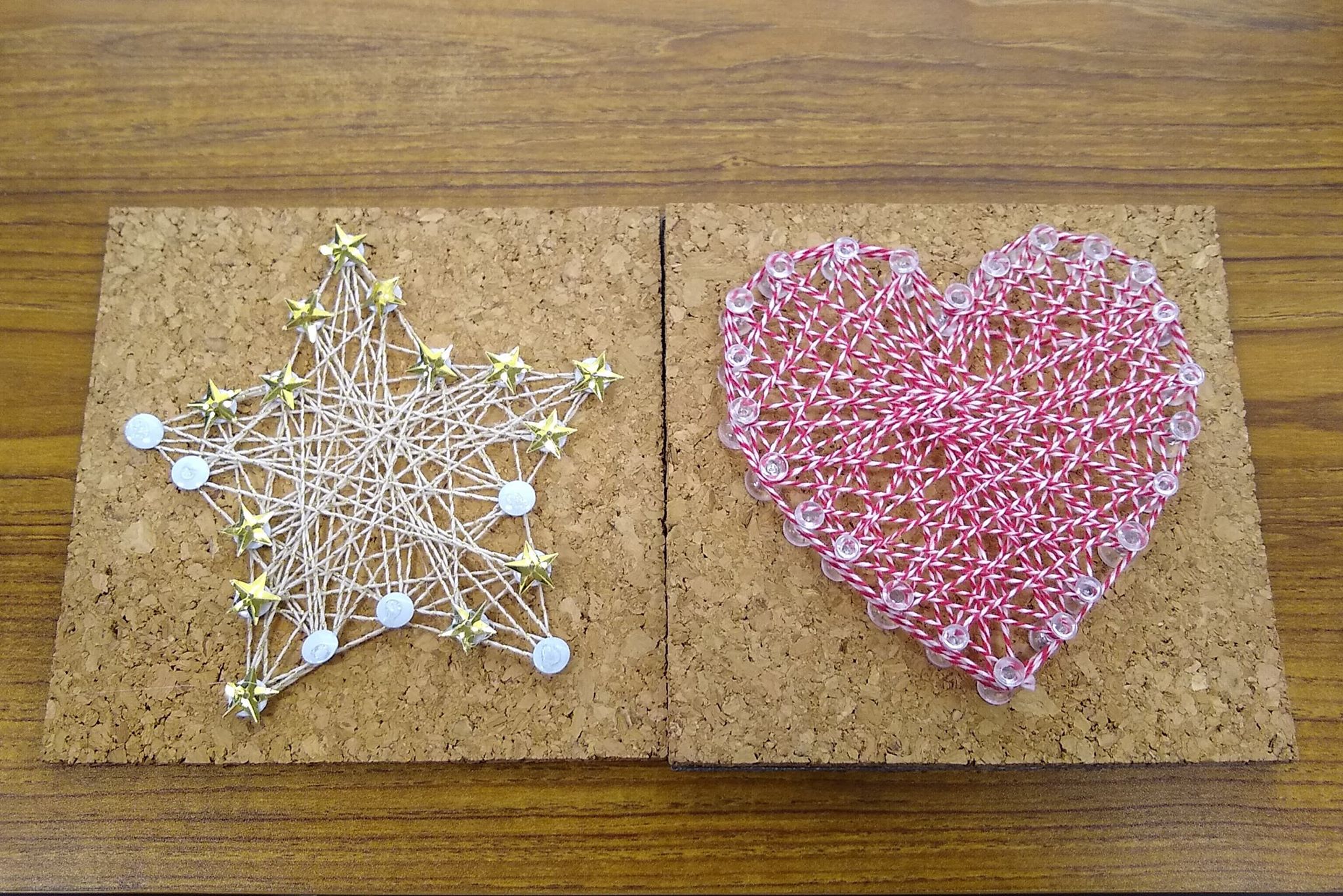 a photo of 2 cork boards with push pins and string, one is a star, the other is a heart