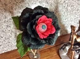 Black and red flower with an eyeball made out of crepe paper