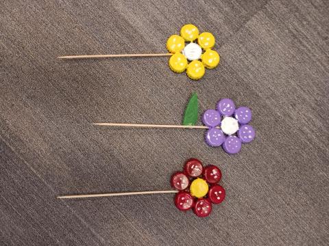 Come have fun painting bottle caps to make a flower decoration!