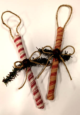 Candy Cane like sticks made from material with holly ornaments.