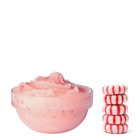 Finished Peppermint Scrub in a bowl next to stacked peppermint candies.