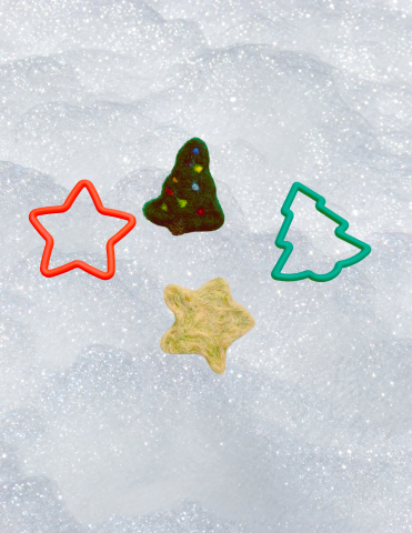 Two plastic cookie cutters (a tree and a star) and the needle felted projects that were made using them as molds. 