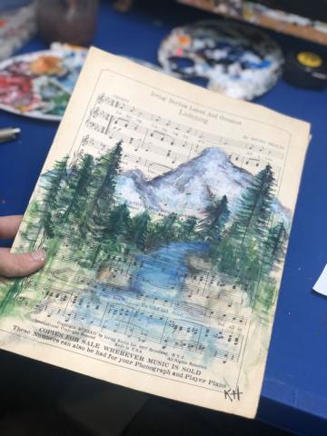 a mountain scene on music sheet paper