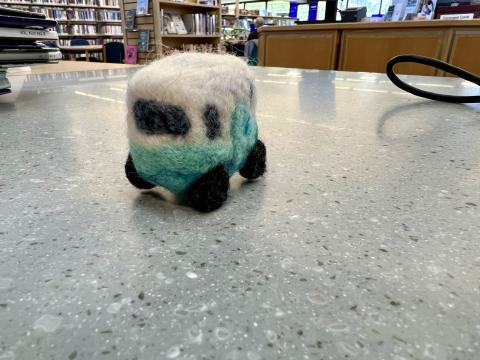 blue and white felted camper on counter top