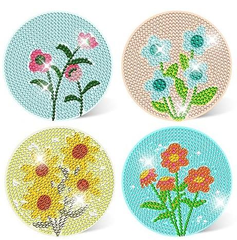 Four round diamond art designs featuring colorful flowers made of sparkling rhinestones.