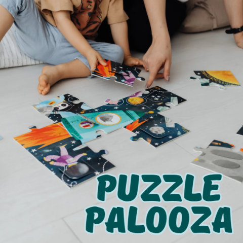 hands putting together a puzzle with the words "puzzle palooza" underneath them, in navy blue font 