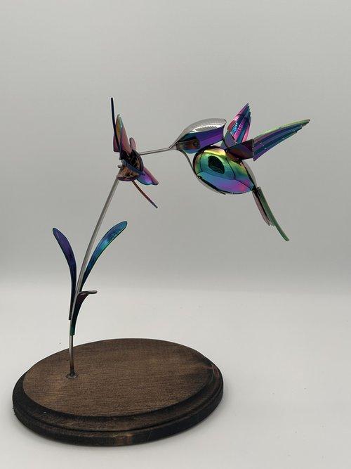 metalwork hummingbird tasting a flower